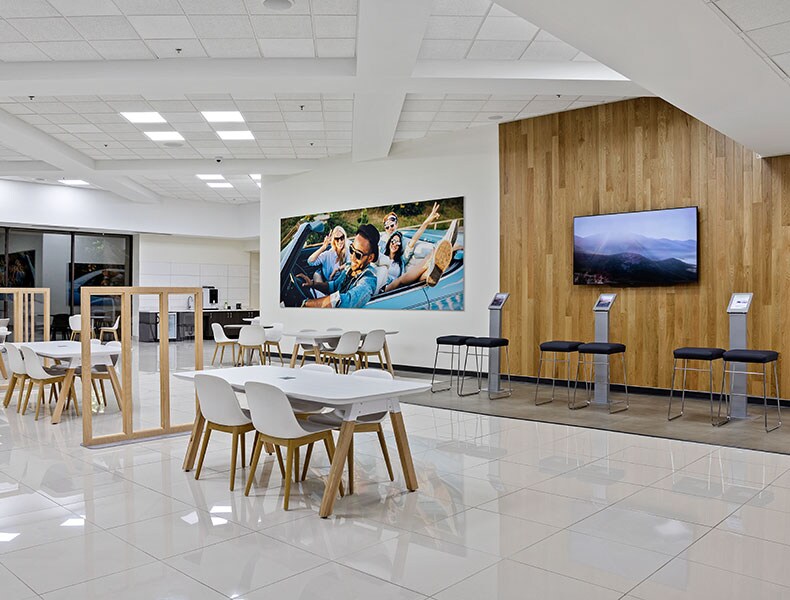 Another view of an EchoPark store, showing a bright interior with modern fixtures and furnishings, and lots of windows. 