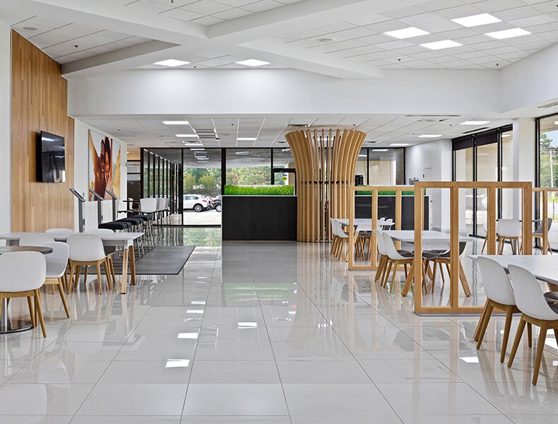 Another view of an EchoPark store, showing a bright interior with modern fixtures and furnishings, and lots of windows. 