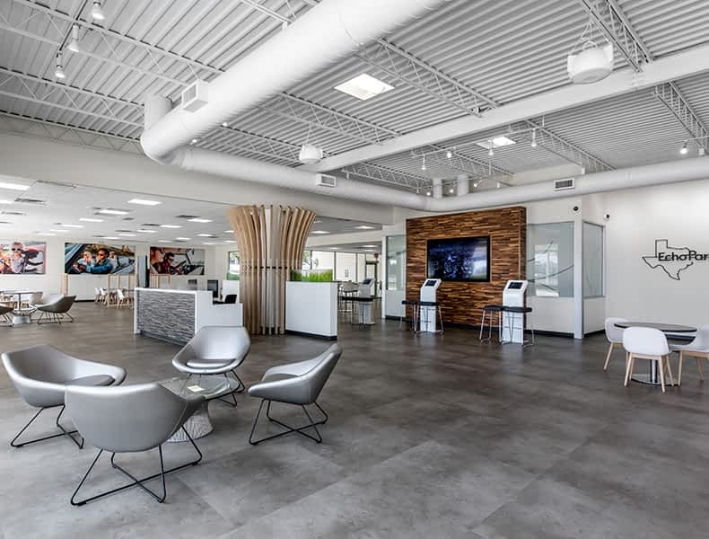 Another view of an EchoPark store, showing a bright interior with modern fixtures and furnishings, and lots of windows.