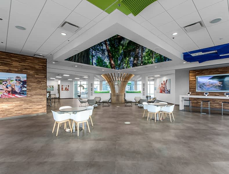 Another view of an EchoPark store, showing a bright interior with modern fixtures and furnishings, and lots of windows. 