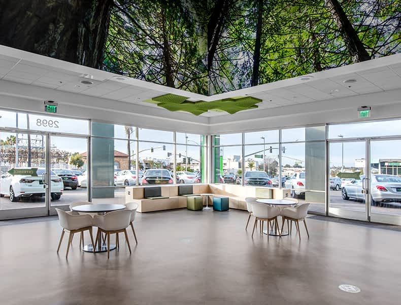 The kids' area of an EchoPark store has colorful blue and green seating and tables, with toy cars on display and children's books to keep the little ones occupied.