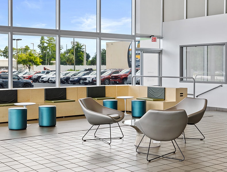 Several EchoPark guests gather inside a light, modern EchoPark store.