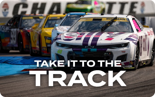 Race cars single file on Charlotte Motor Speedway track with NASCAR Driver Alex Bowman’s white Chevrolet in front.
