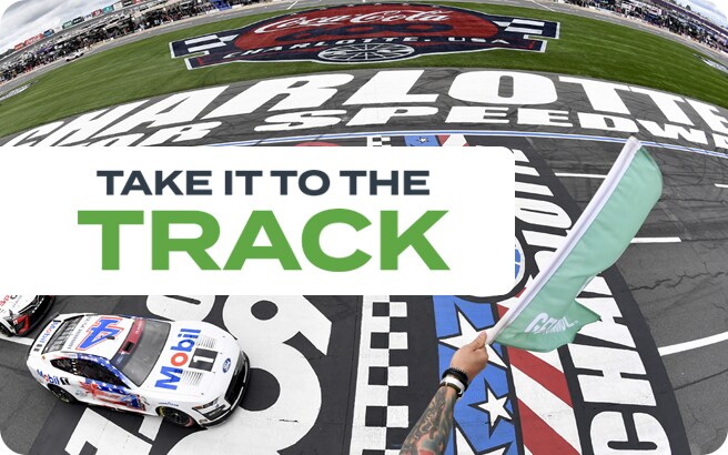 The checkered finish line at Charlotte Motor Speedway with 5 NASCAR race cars and green flag at the Coca-Cola 600.