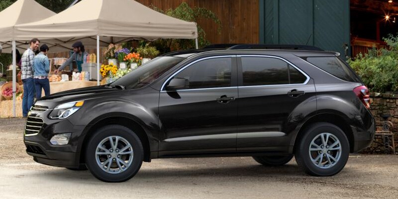 Image shows a black Chevrolet Equinox parked at a farmer’s market.