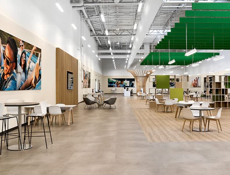 Another view of an EchoPark store, showing a bright interior with modern fixtures and furnishings, and lots of windows. 