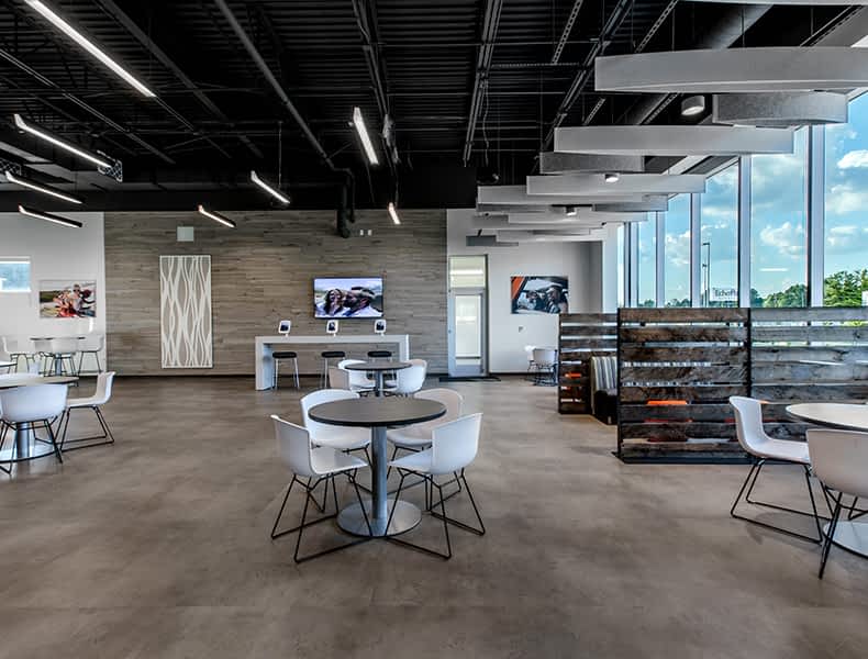 Another view of an EchoPark store, showing a bright interior with modern fixtures and furnishings, and lots of windows. 