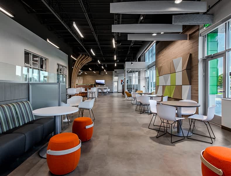 Another view of an EchoPark store, showing a bright interior with modern fixtures and furnishings, and lots of windows. 