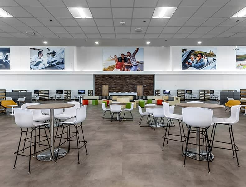 Another view of an EchoPark store, showing a bright interior with modern fixtures and furnishings, and lots of windows.