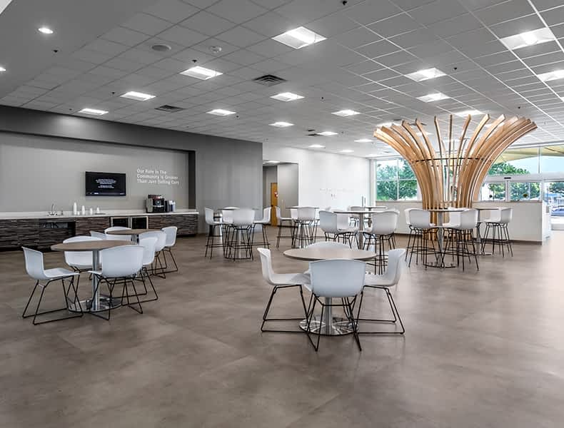Another view of an EchoPark store, showing a bright interior with modern fixtures and furnishings, and lots of windows.