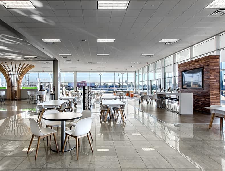 Another view of an EchoPark store, showing a bright interior with modern fixtures and furnishings, and lots of windows.