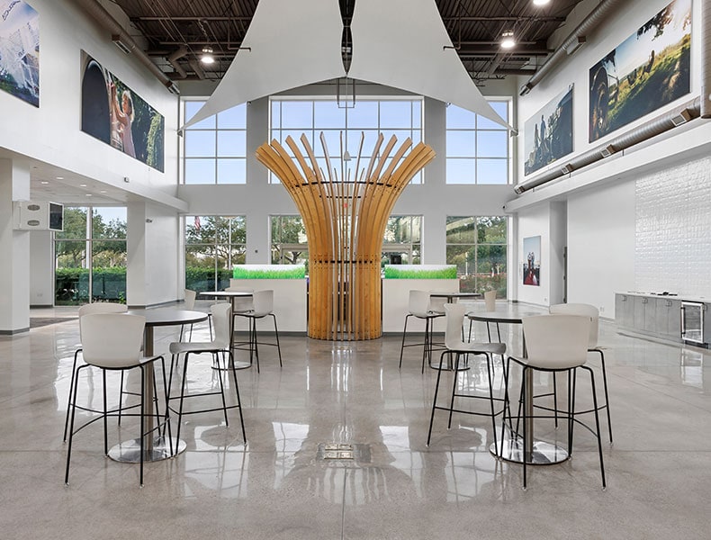A large interior showroom space containing high top tables and stools for the comfort of EchoPark guests.