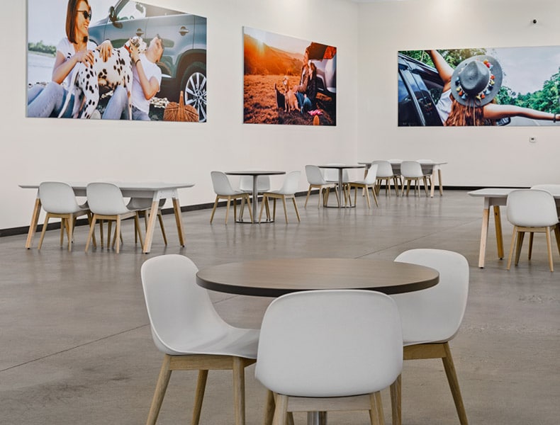 Another view of an EchoPark store, showing a bright interior with modern fixtures and furnishings, and lots of windows.