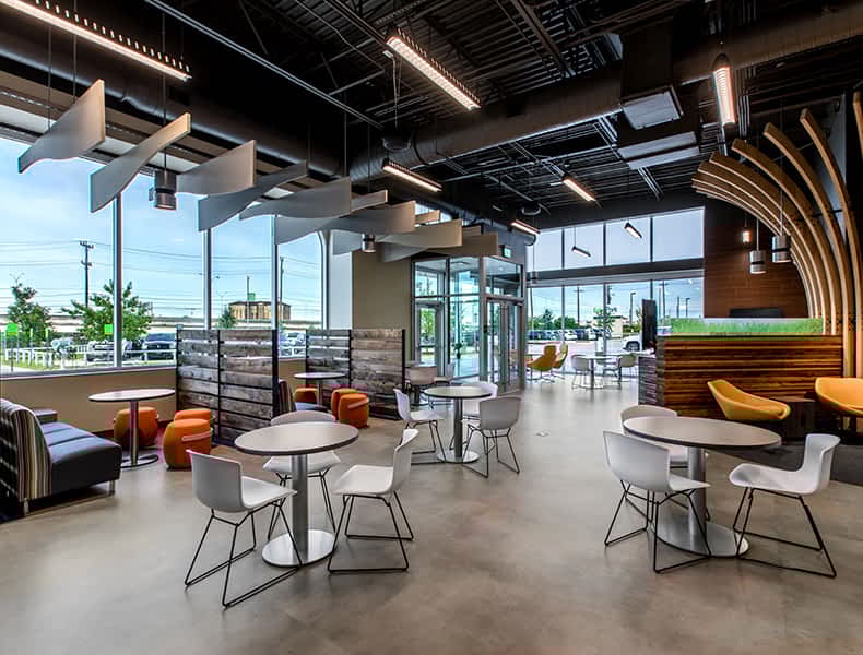 Another view of an EchoPark store, showing a bright interior with modern fixtures and furnishings, and lots of windows. 