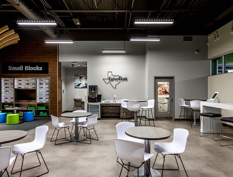 Another view of an EchoPark store, showing a bright interior with modern fixtures and furnishings, and lots of windows. 