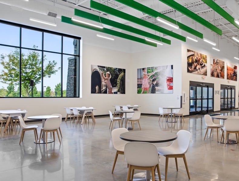 Another view of an EchoPark store, showing a bright interior with modern fixtures and furnishings, and lots of windows. 