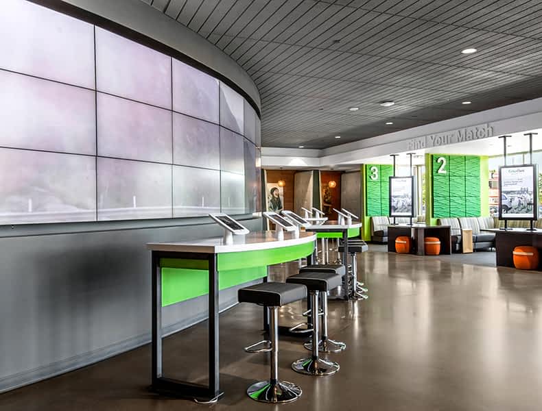 Another view of an EchoPark store, showing a bright interior with modern fixtures and furnishings, and lots of windows. 