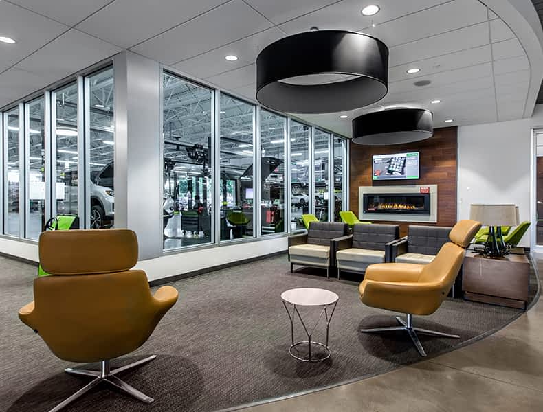Another view of an EchoPark store, showing a bright interior with modern fixtures and furnishings, and lots of windows. 
