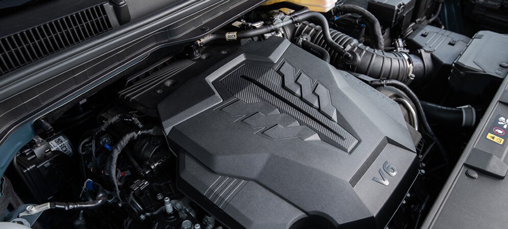 The engine bay of the Kia Carnival highlighting the V6 engine powerplant.