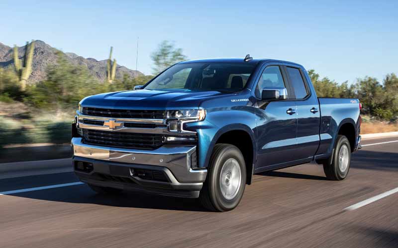 Chevrolet Silverado driving on a road in the desert. 