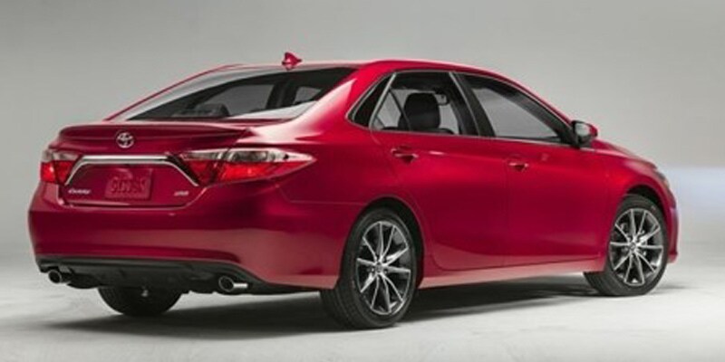 Image shows a red Toyota Camry on a gray background.